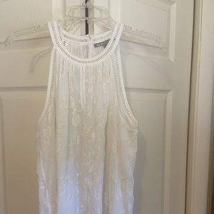 White sleeveless blouse.